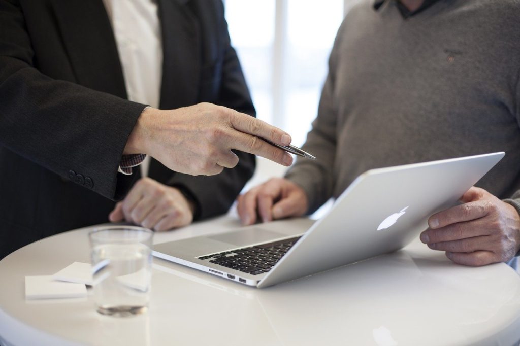 two men consulting with one another